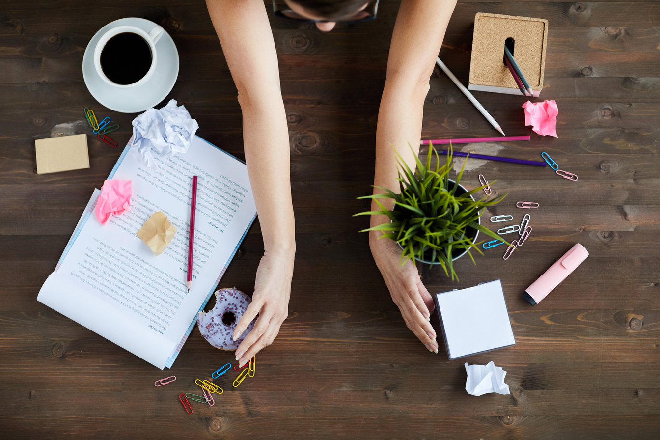 Woman Tidying Up Office Desk